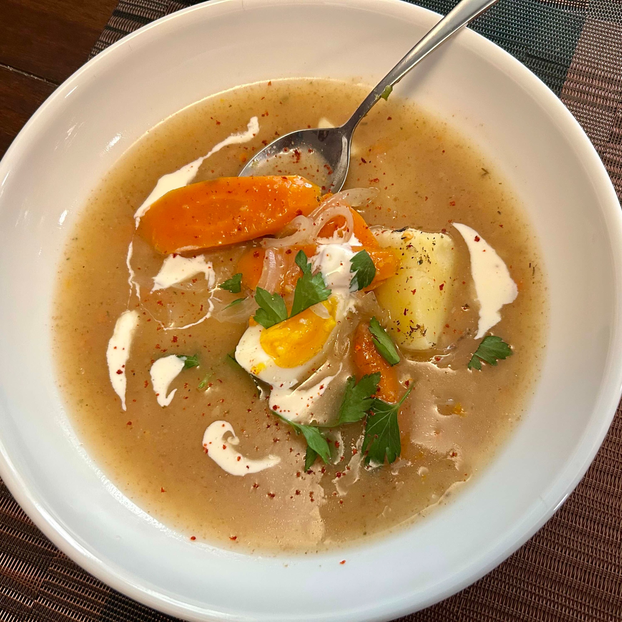 Żurek with sausage, egg, potatoes, and vegetables